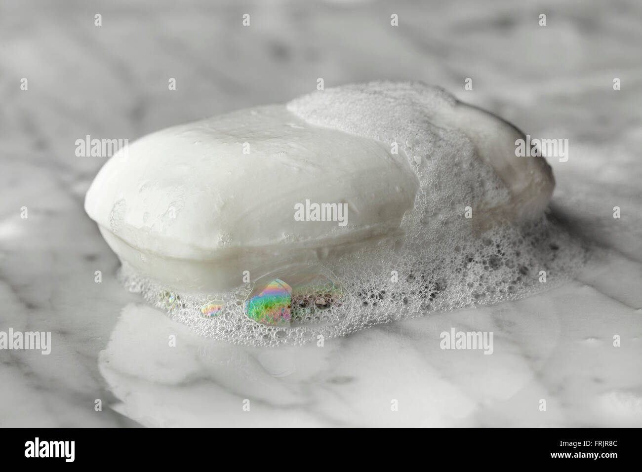 Bar of wet white soap with foam Stock Photo