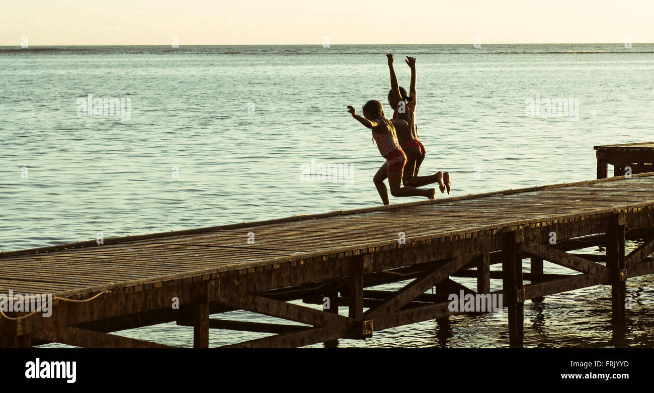 Children jumping off pier Stock Photo Alamy