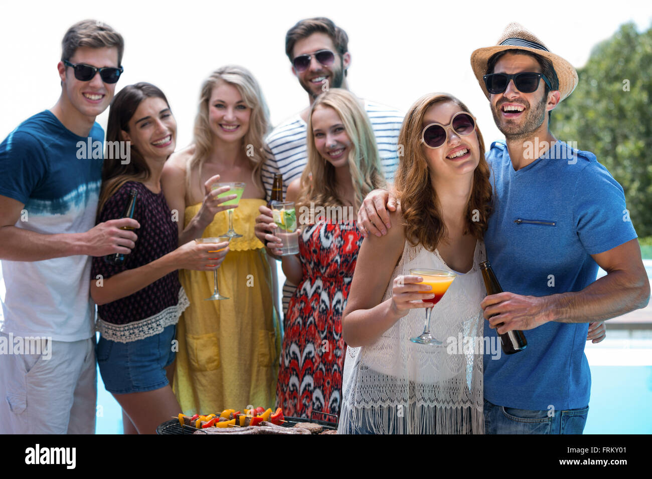 Group of friends holding a glass of cocktail Stock Photo