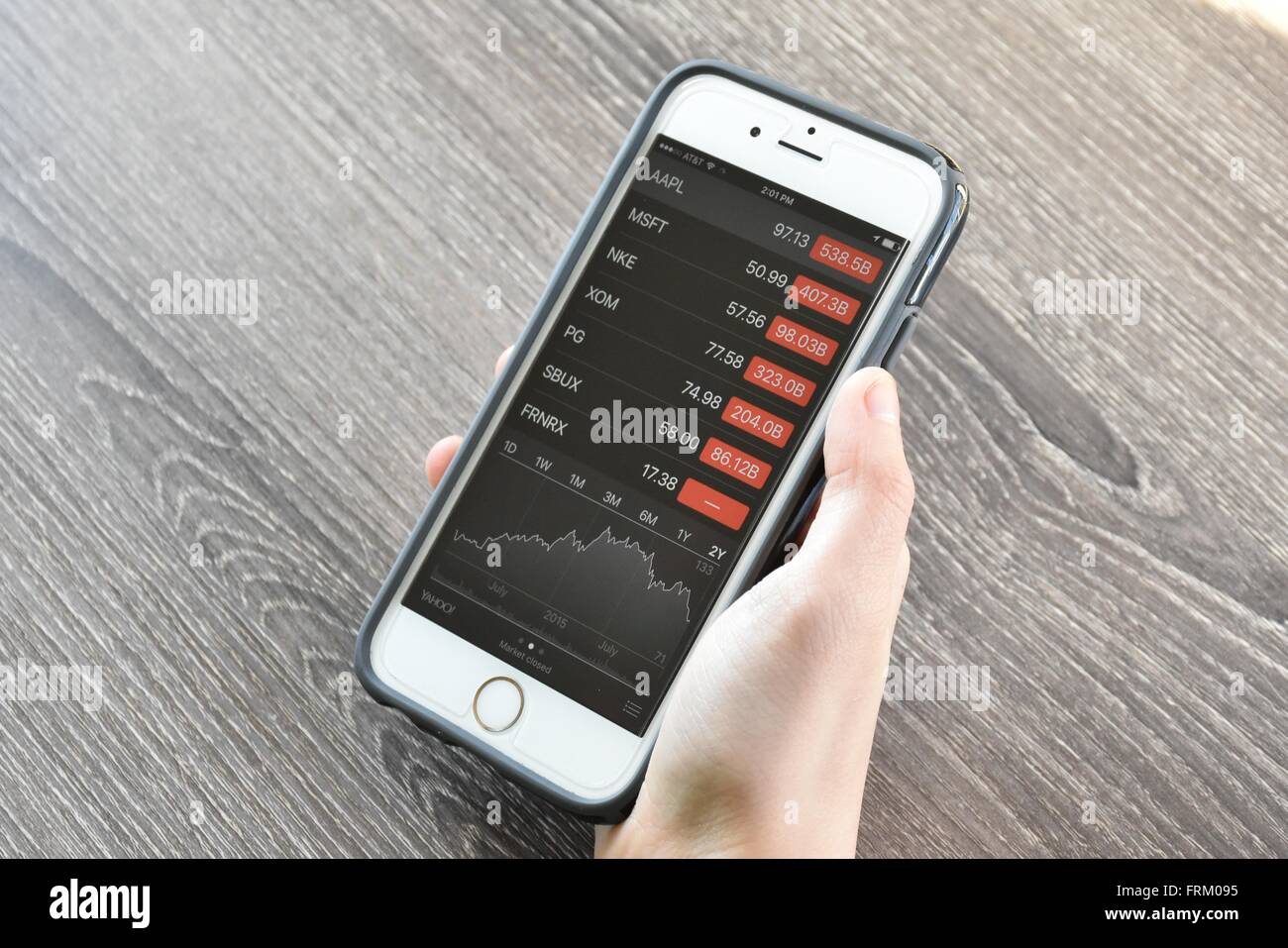 Apple iPhone displaying stock market information Stock Photo