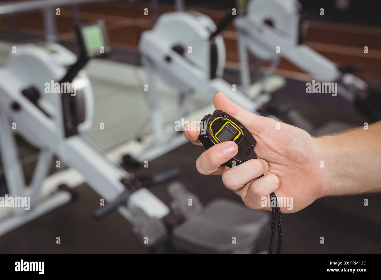 Hand of a trainer holding a stopwatch Stock Photo Alamy