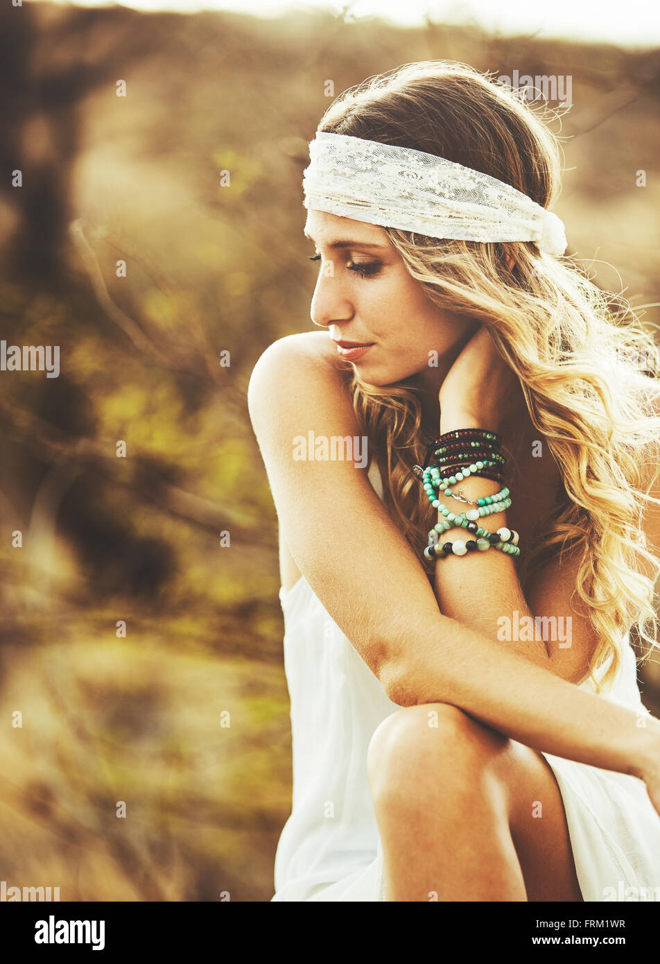 Fashion Lifestyle. Fashion Portrait of Beautiful Young Woman Outdoors. Soft warm vintage color tone. Artsy Bohemian Style. Stock Photo