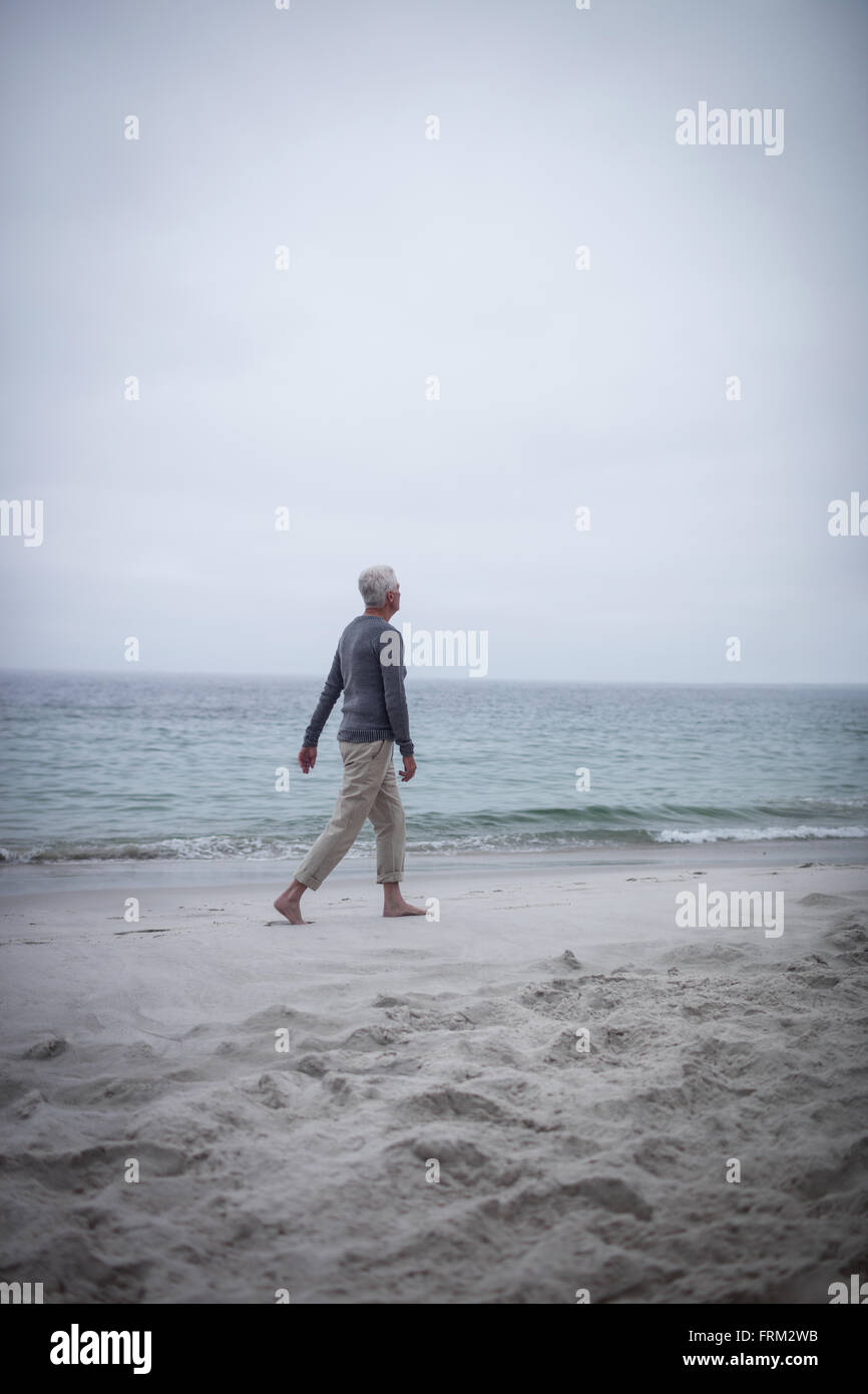 Man walking on the beach hi-res stock photography and images - Alamy