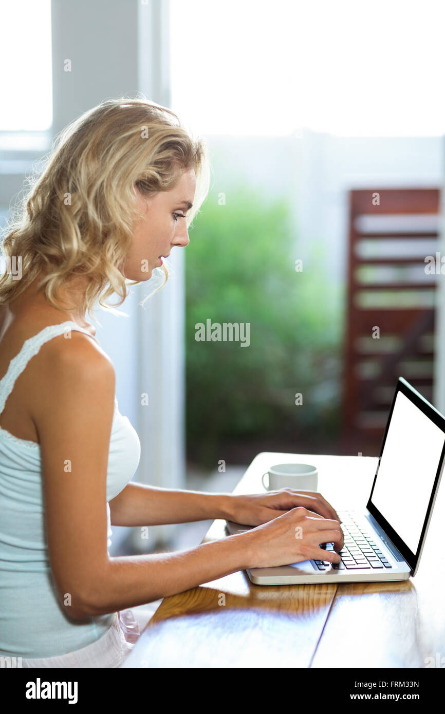 Young woman working on laptop Stock Photo - Alamy