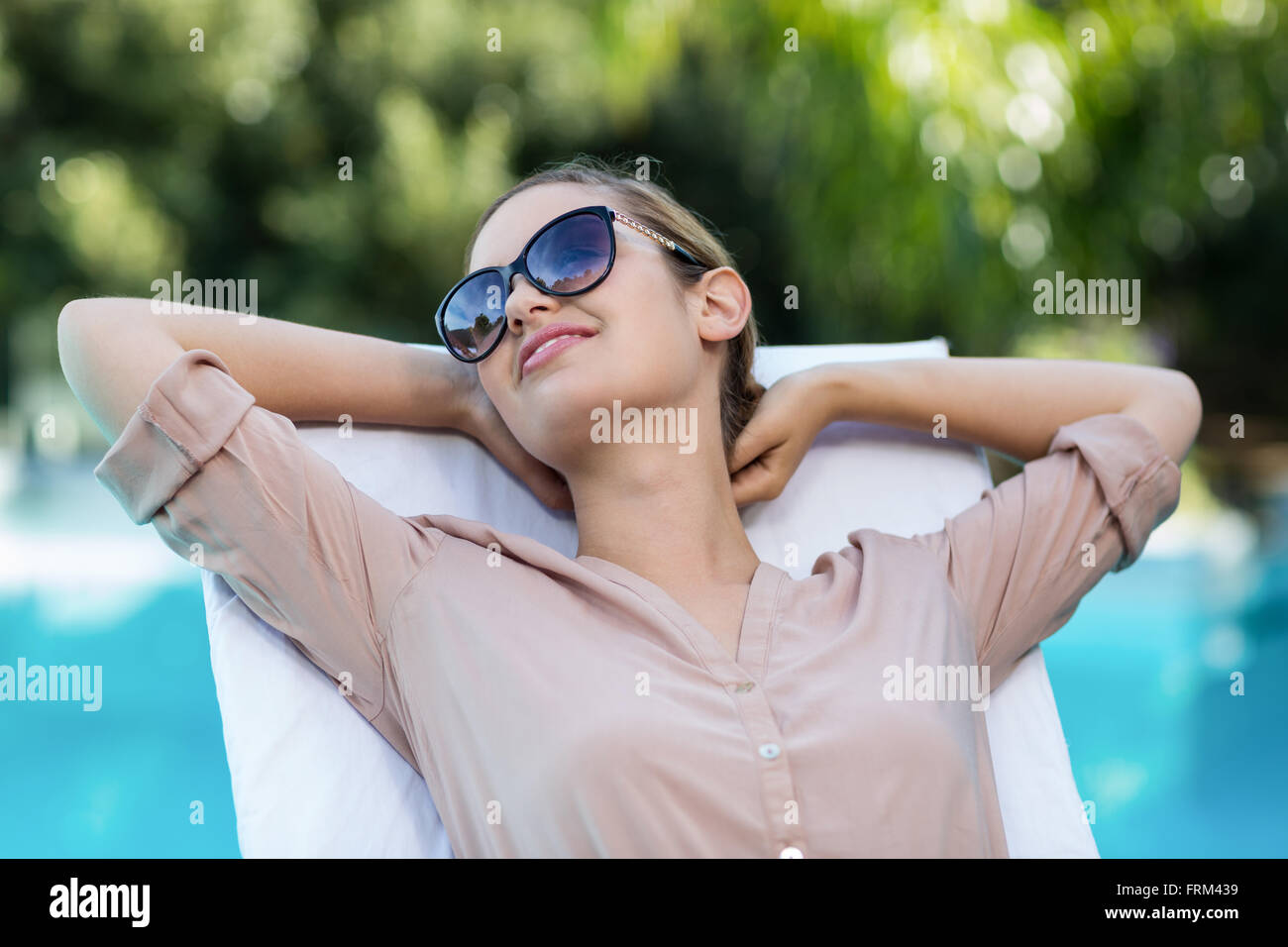 Business woman relaxing on sun lounger Stock Photo - Alamy