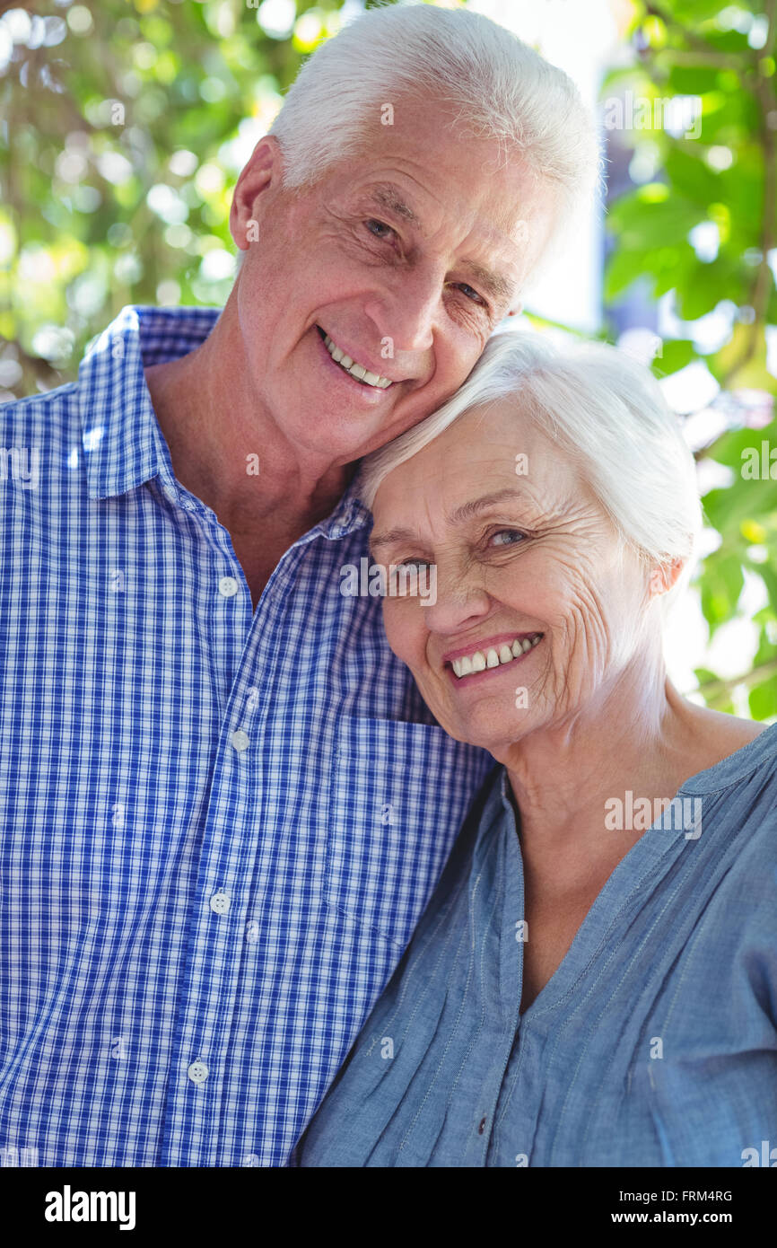 Satisfied senior couple with arm around Stock Photo