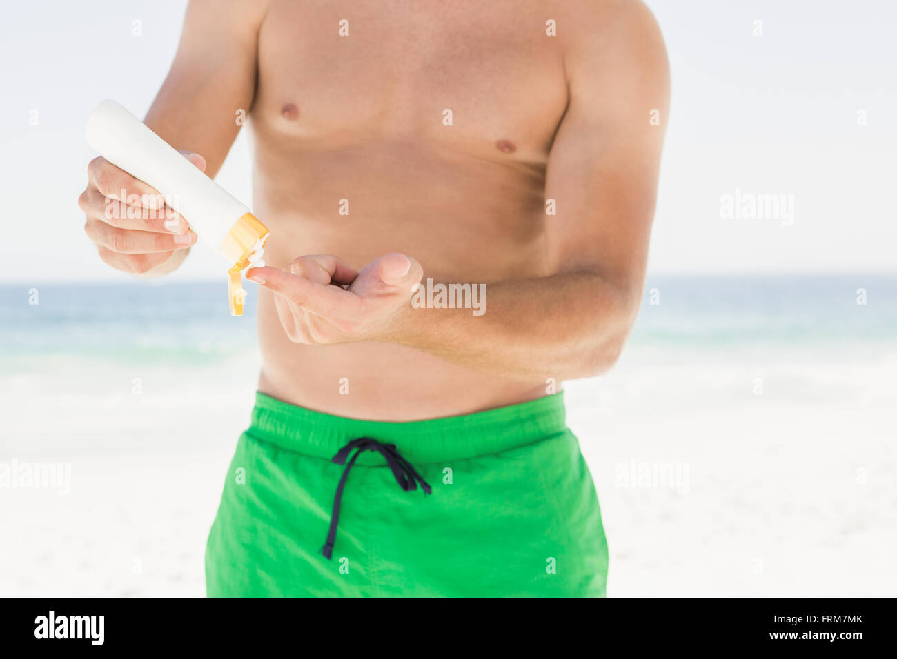 Portrait of man applying sun cream Stock Photo