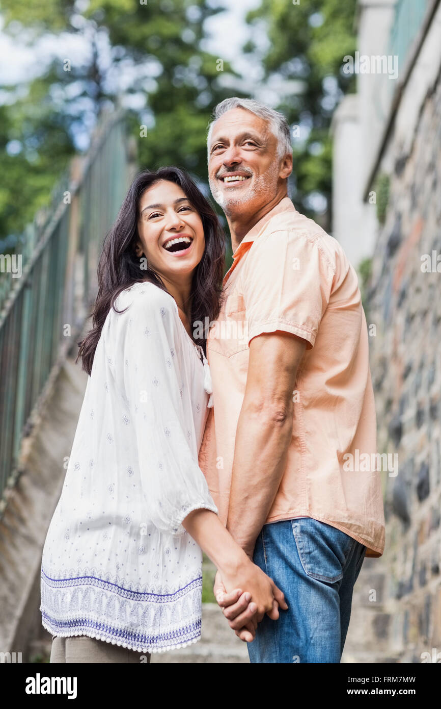 Cheerful couple looking over shoulder Stock Photo