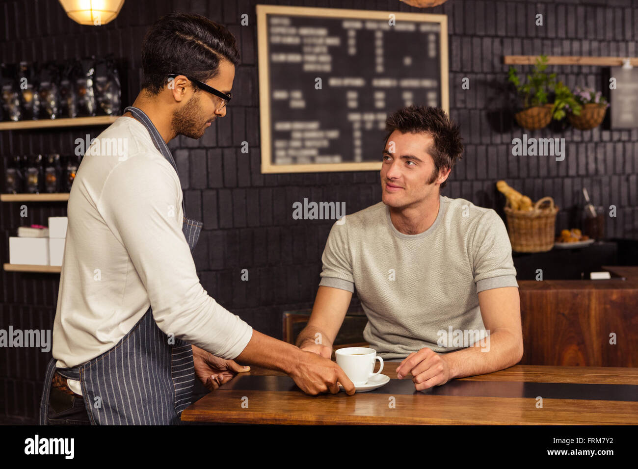 Waiter serving a coffee Stock Photo Alamy