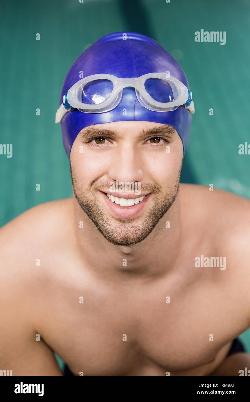 Portrait of swimmer wearing swimming goggles and cap Stock Photo