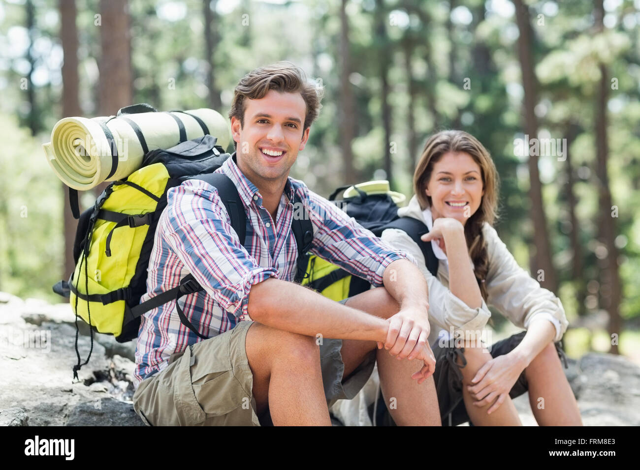 Male and female sitting on rock hi-res stock photography and images - Alamy