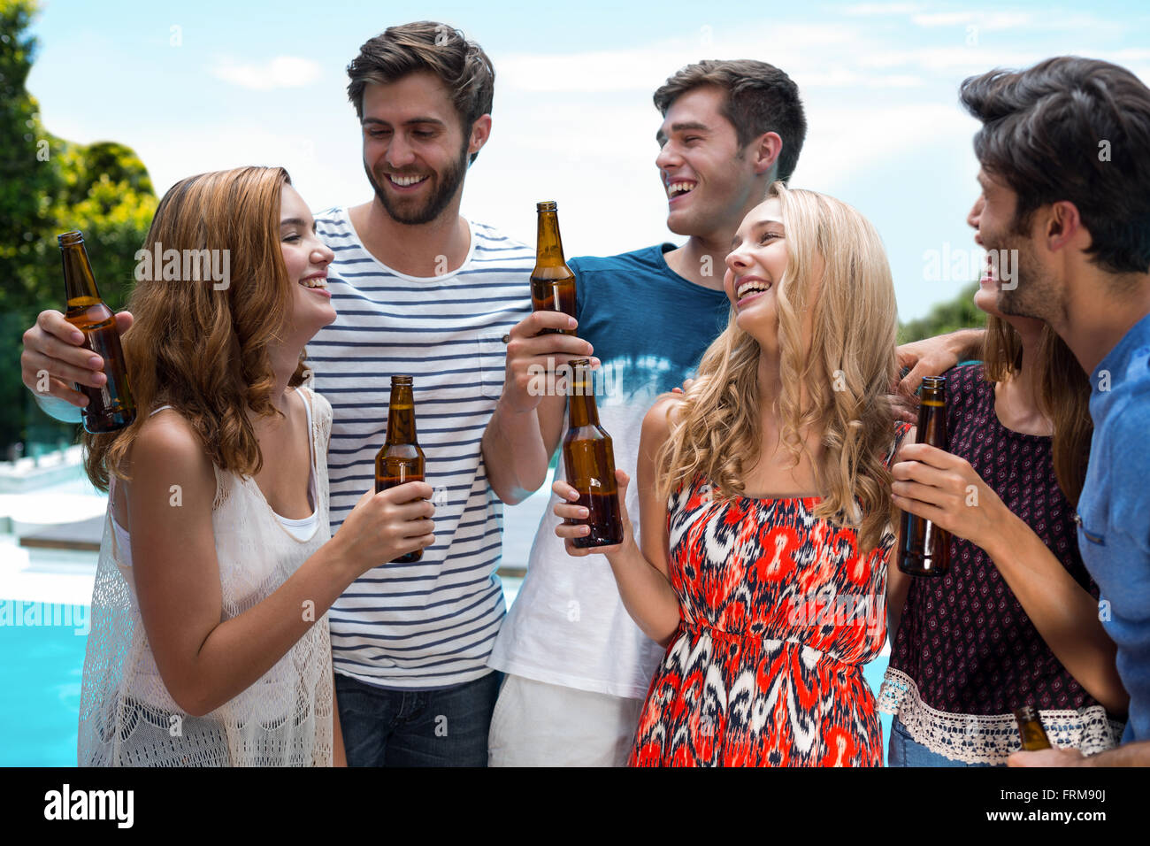 Group of happy friend holding beer bottles Stock Photo