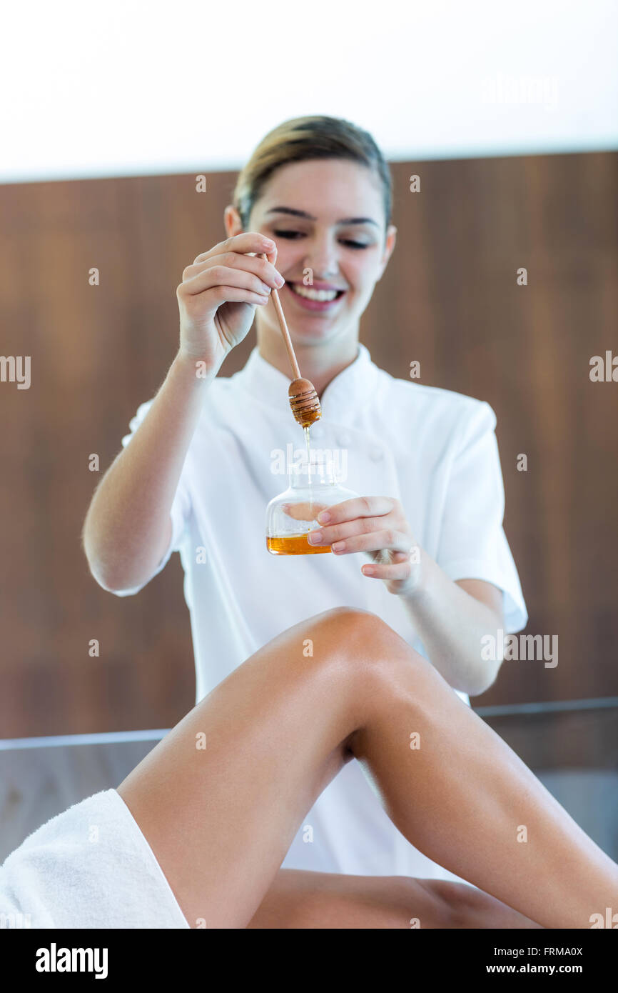 Woman receiving spa treatment with honey Stock Photo