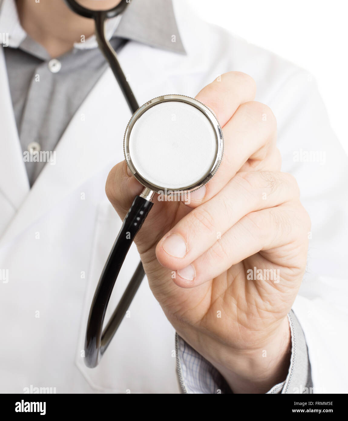 Medical doctor with a stethoscope and hands behind his back Stock Photo -  Alamy