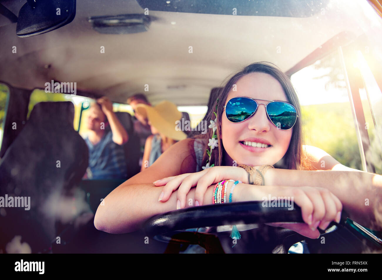 Teenage boys and girls inside an old campervan, roadtrip Stock Photo