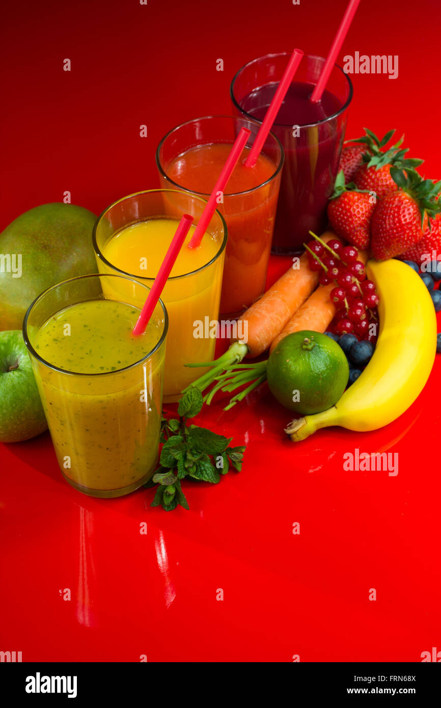 Colorful fresh pressed fruit green, yellow, oragne and red juices with