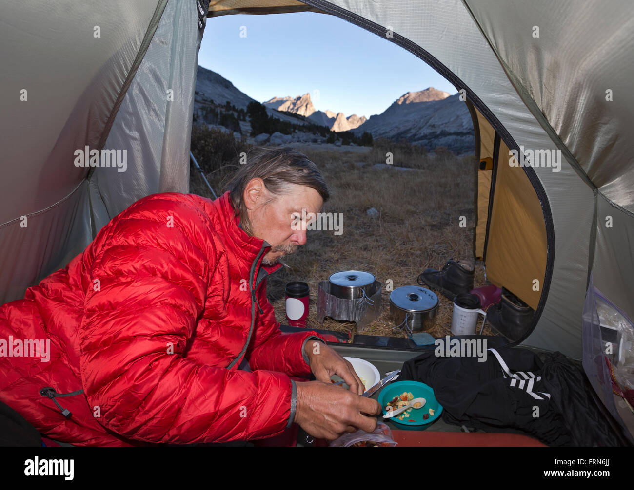 WYOMING - Preparing breakfast on a chilly morning near Deep Lake in the Bridger Wilderness section of the Wind River Range. Stock Photo