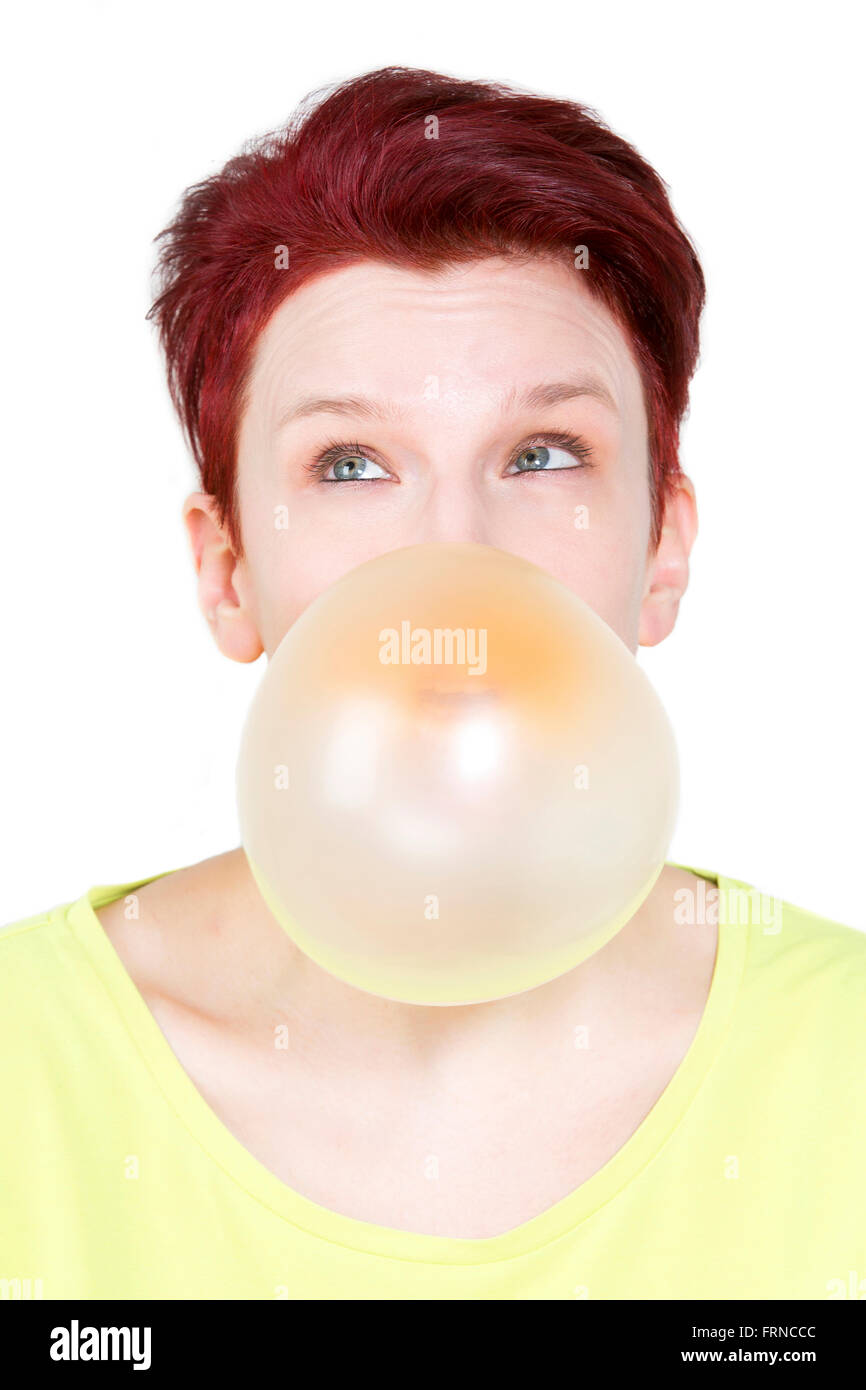 redhaired woman blowing a big bubble of chewing gum Stock Photo Alamy