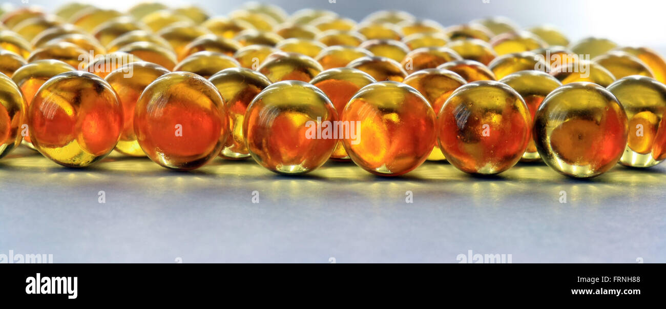 round fish oil capsules closeup Stock Photo