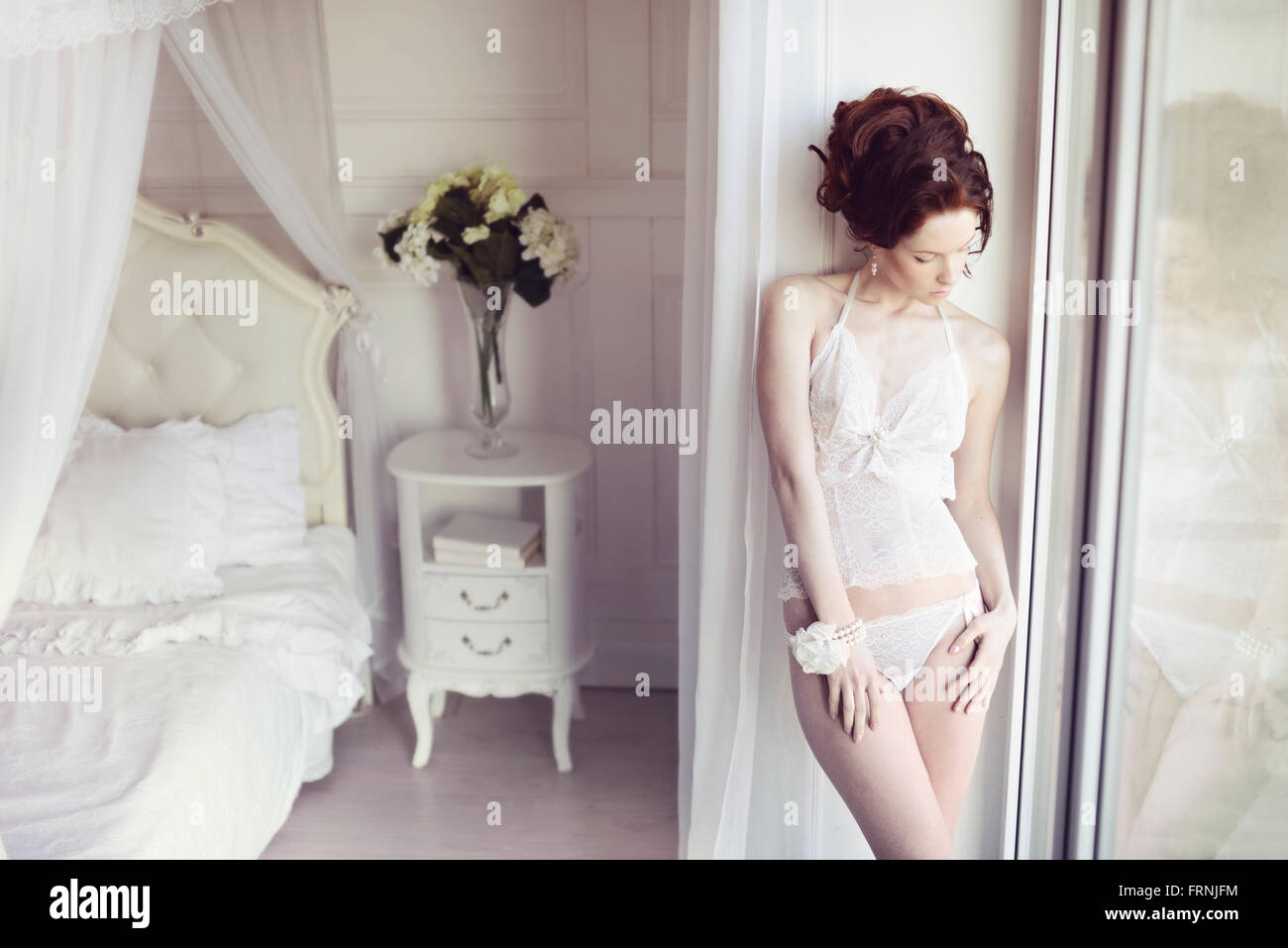 Beautiful sexy lady in elegant white panties and bra. Fashion portrait of  model indoors Stock Photo - Alamy