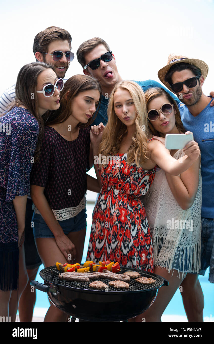 Group of friends taking a selfie near pool Stock Photo