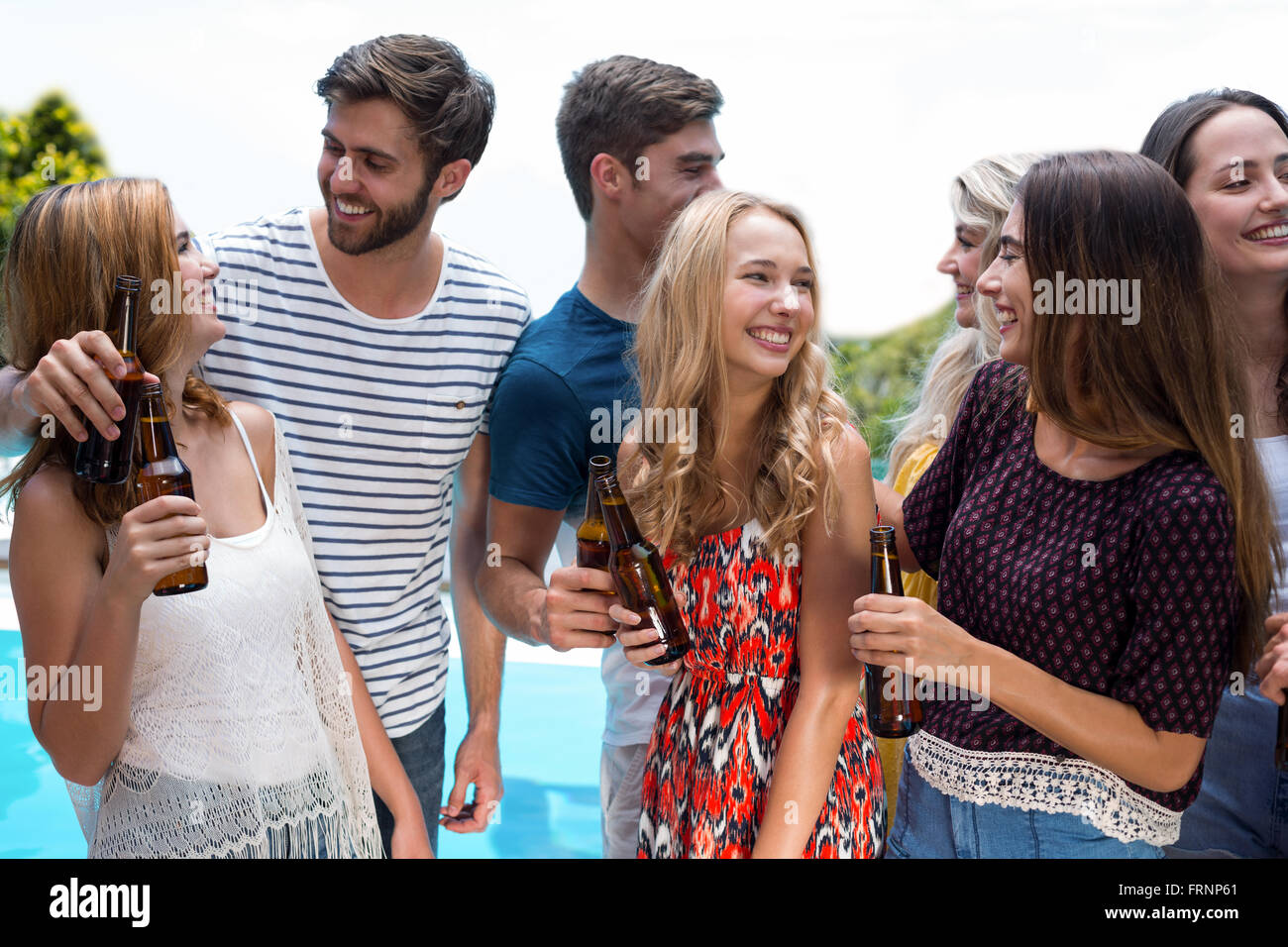 Group of happy friend holding beer bottles Stock Photo