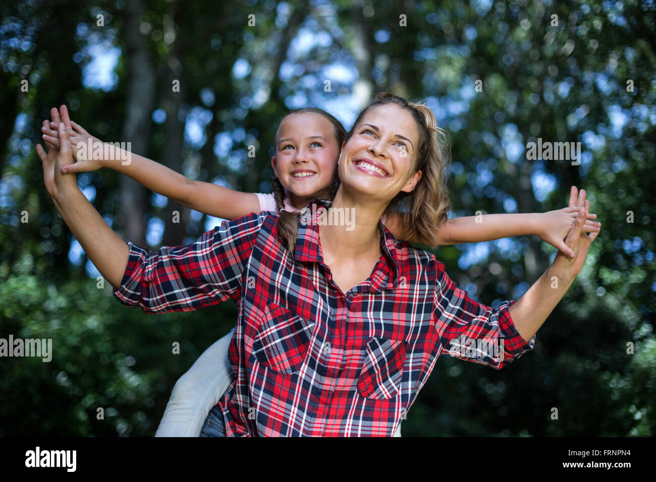 Playful mother and daughter looking up Stock Photo