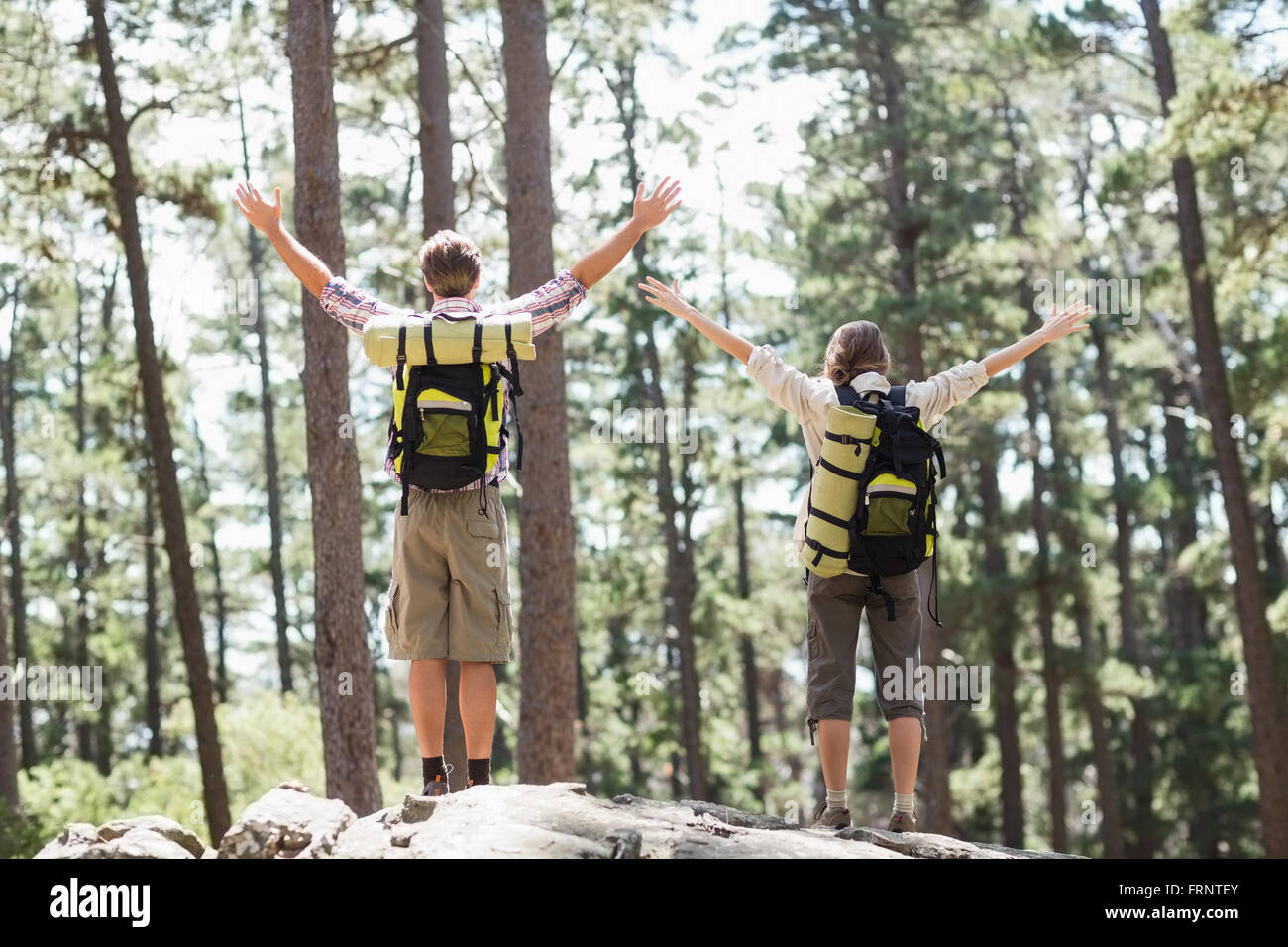 Rear view of couple with arms raised Stock Photo