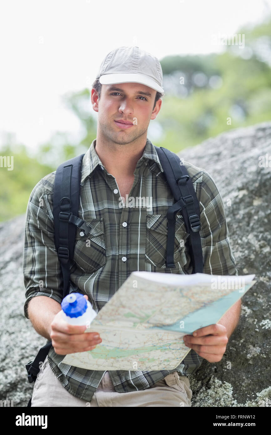 Young man standing with bottle and map Stock Photo