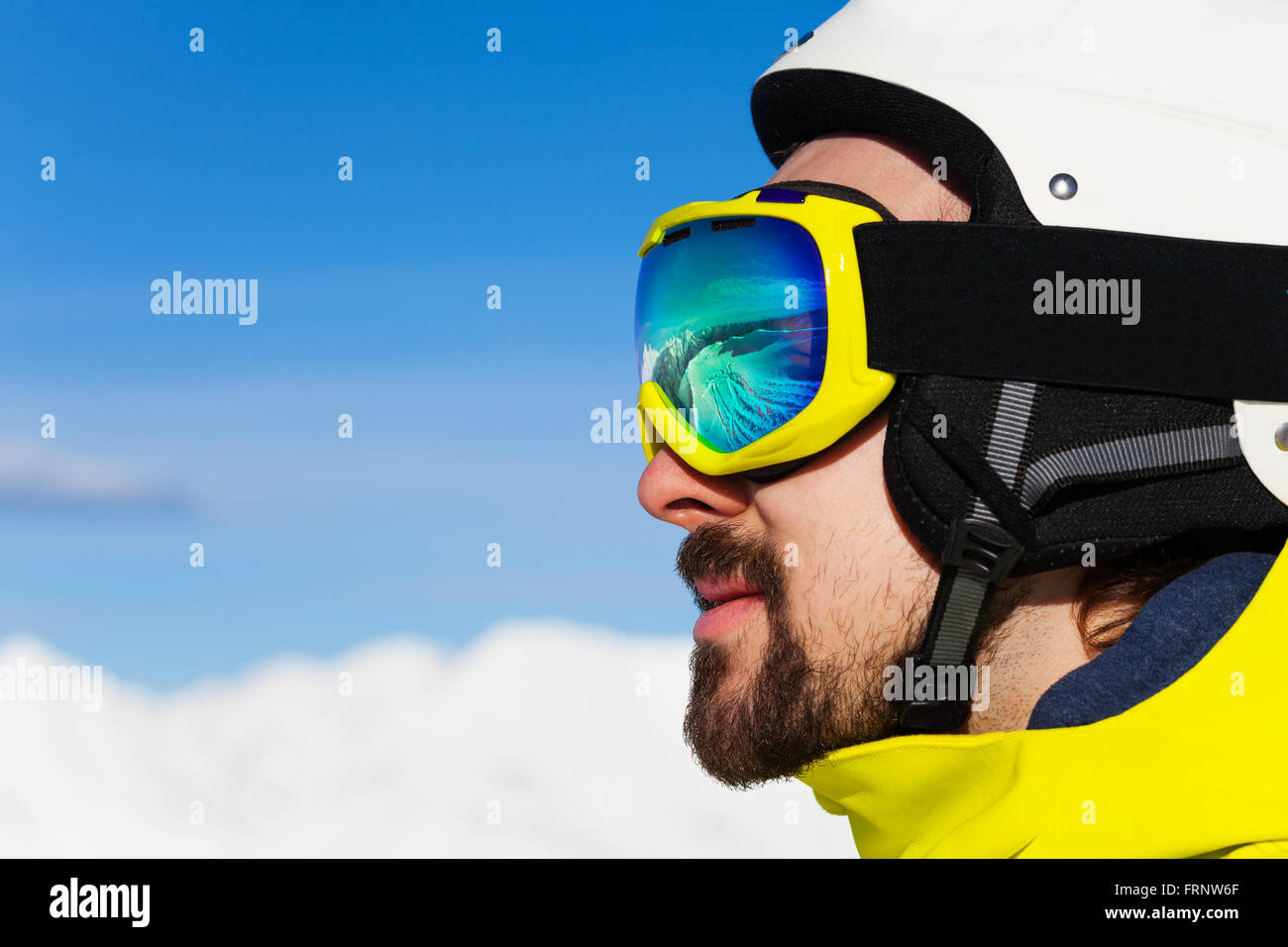 Close portrait of man in ski mask over mountains Stock Photo