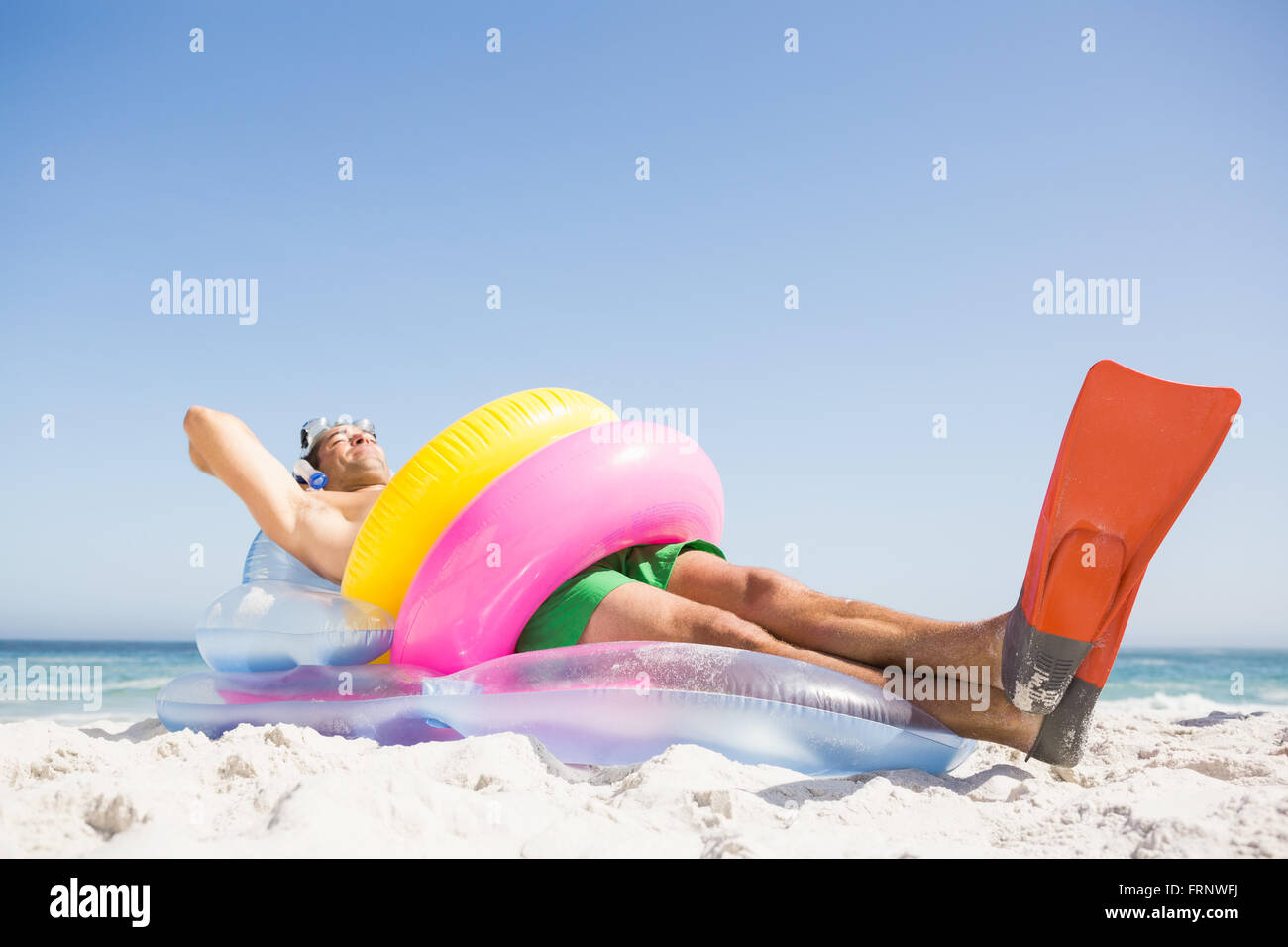 Man lying on lilo wearing rubber ring Stock Photo - Alamy