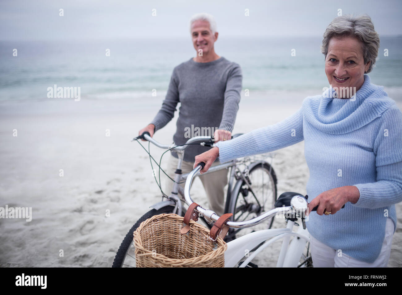 Happy senior couple with their bike Stock Photo