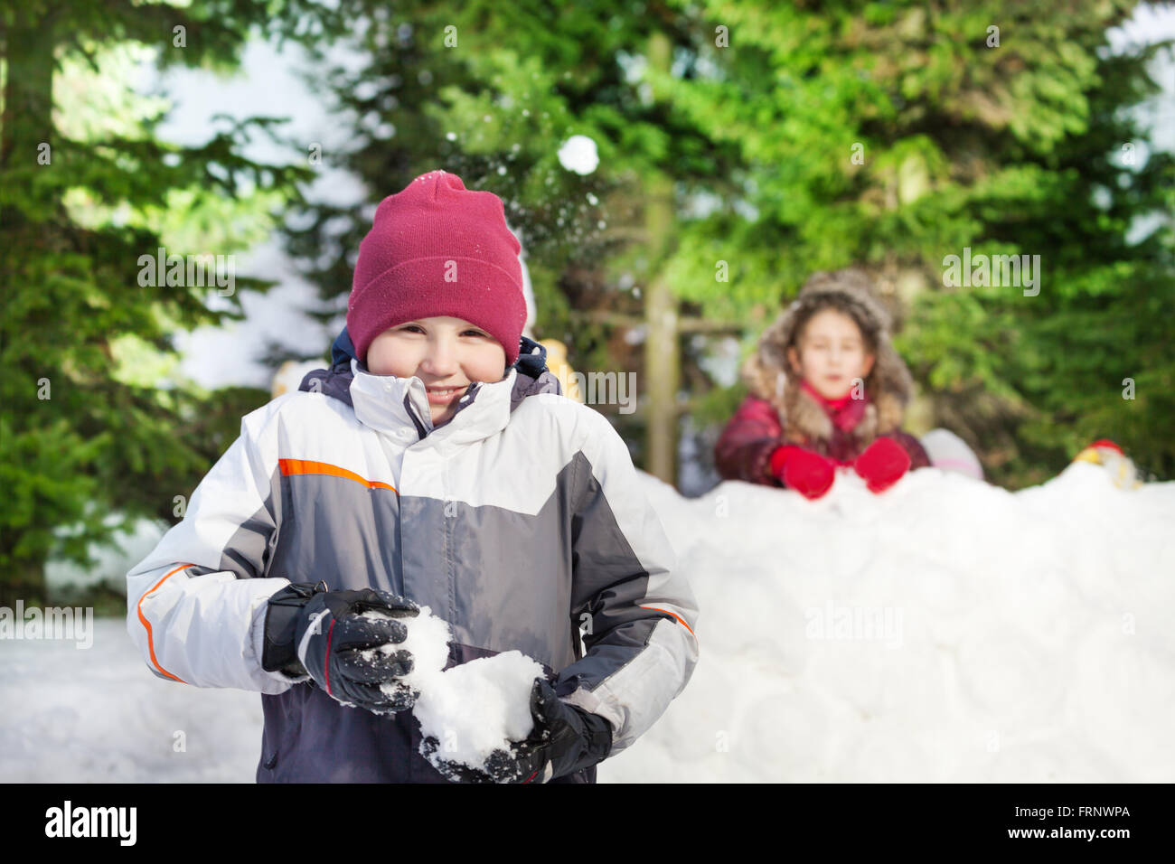 Two friends having snowball fight Stock Photo