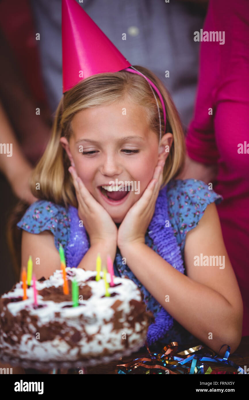 Shocked girl with birthday cake Stock Photo