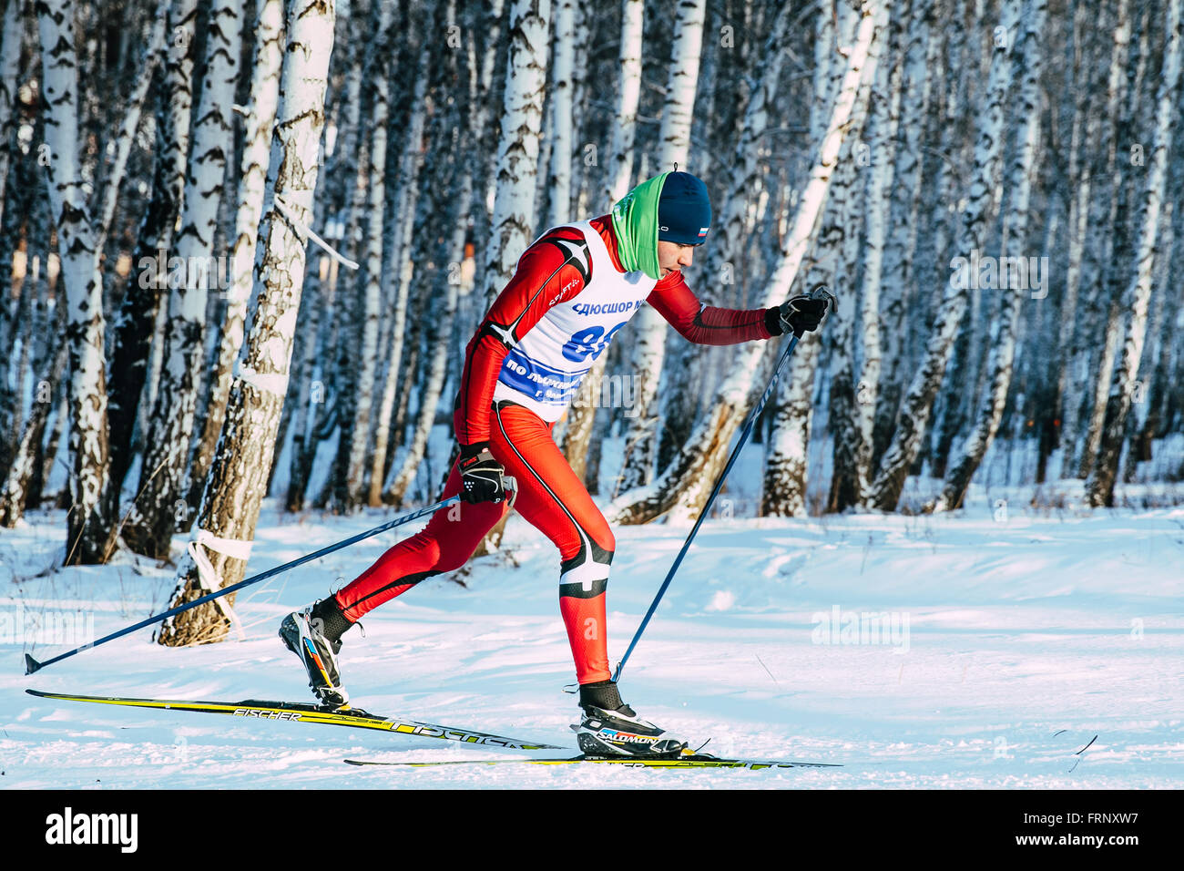 closeup skier athlete winter birch forest sprint race in classic style during Championship of Chelyabinsk in cross-country skii Stock Photo