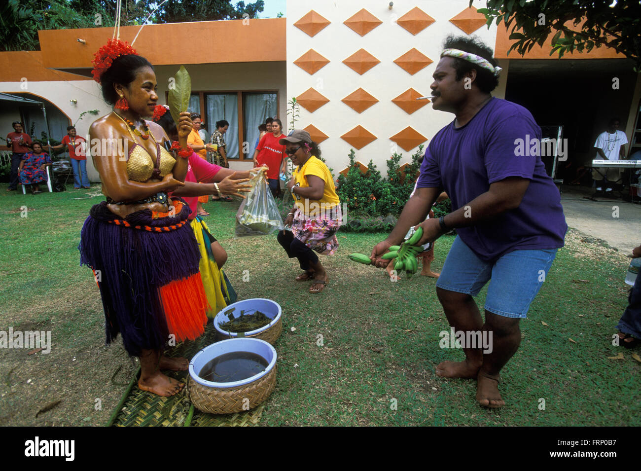 At a first childbirth ritual in Palau the husband's family dance with the young mother and present her with gifts. Stock Photo
