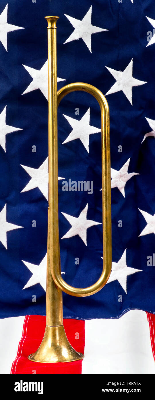 Brass bugle on a American flag. Stock Photo
