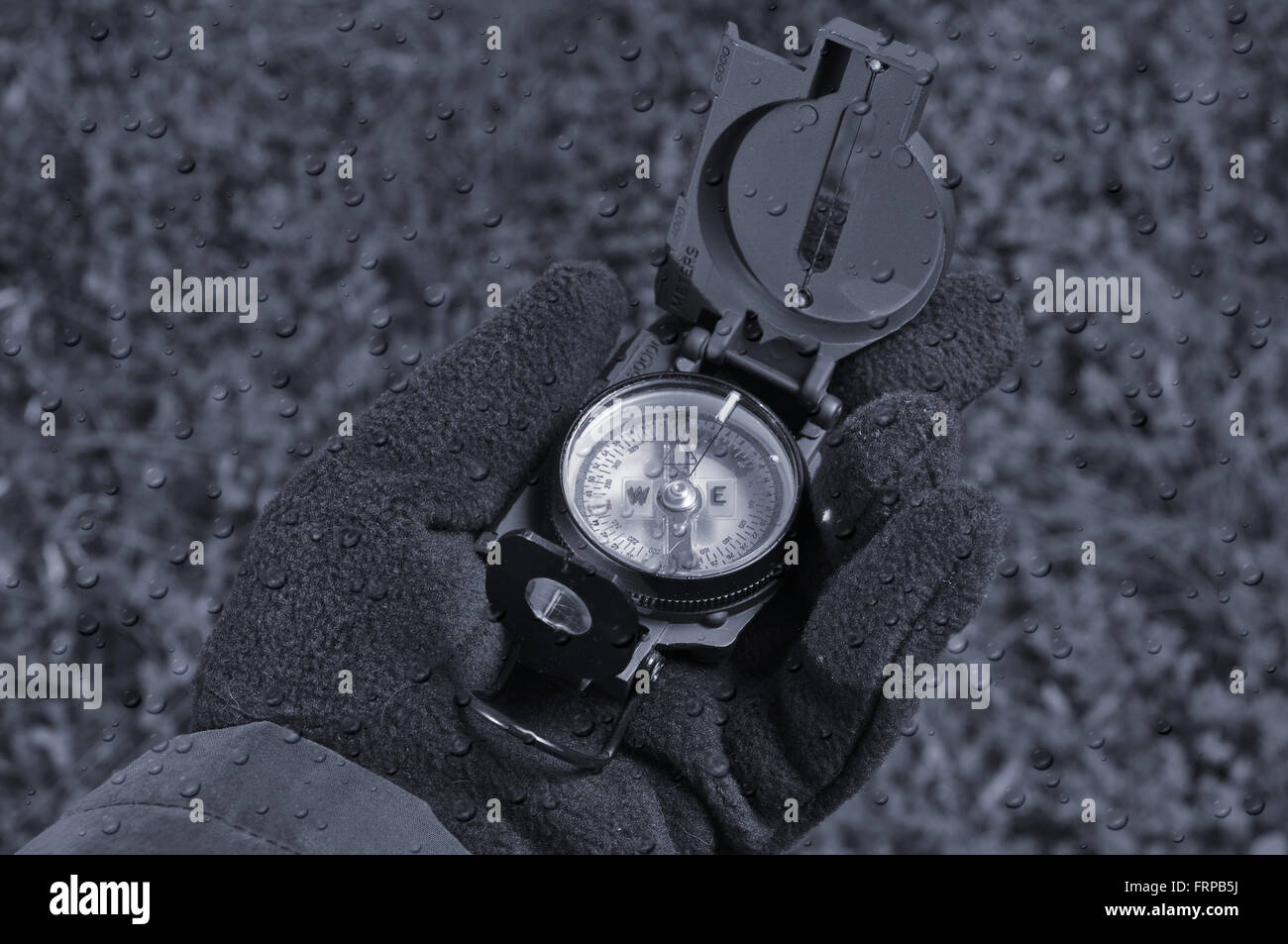 Handling a military compass. Survival, outdoors and military monochrome theme Stock Photo