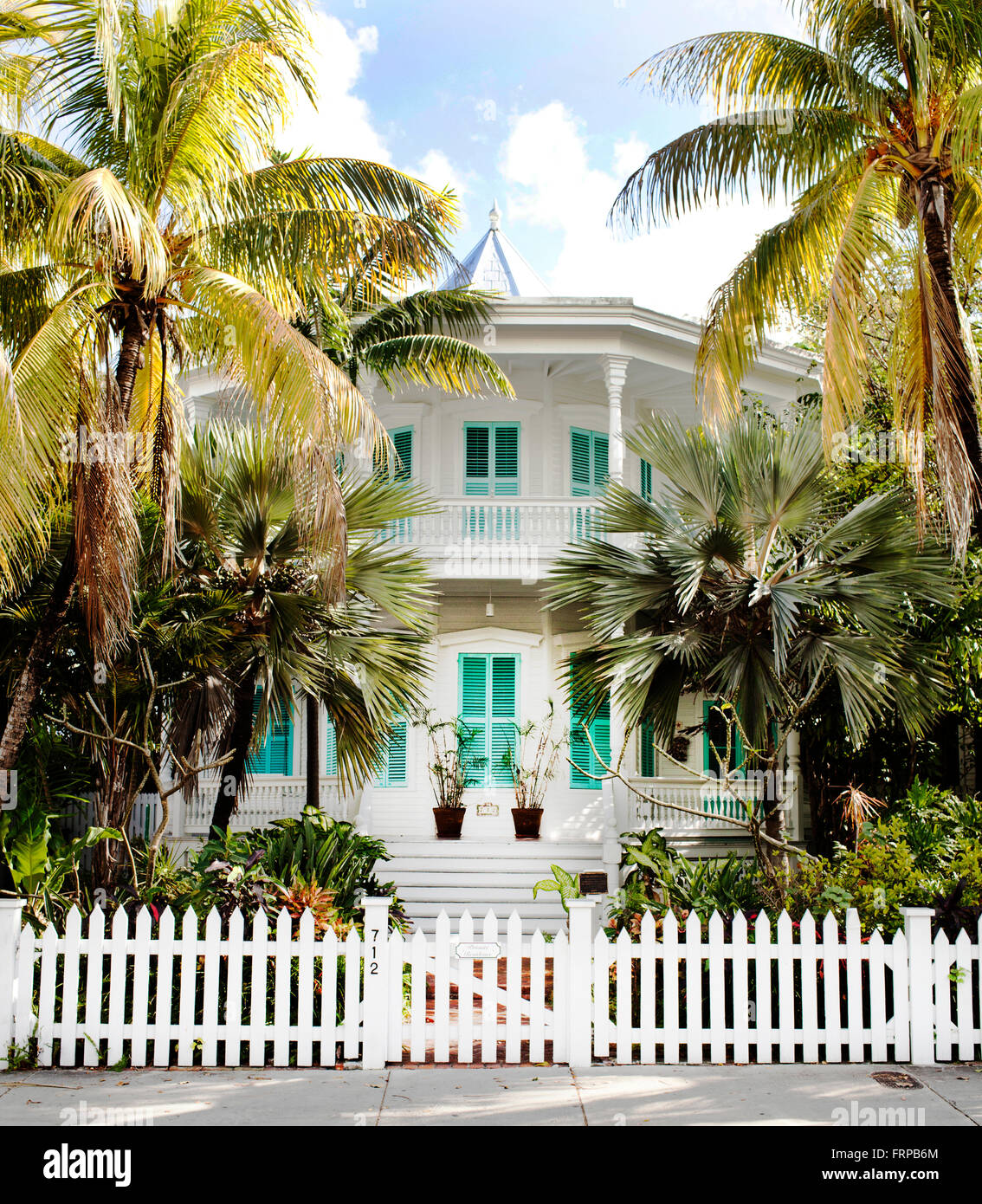 Key West, Florida, USA. A stately white and teal two-story house behind a  picket fence and bordered by palm trees Stock Photo - Alamy