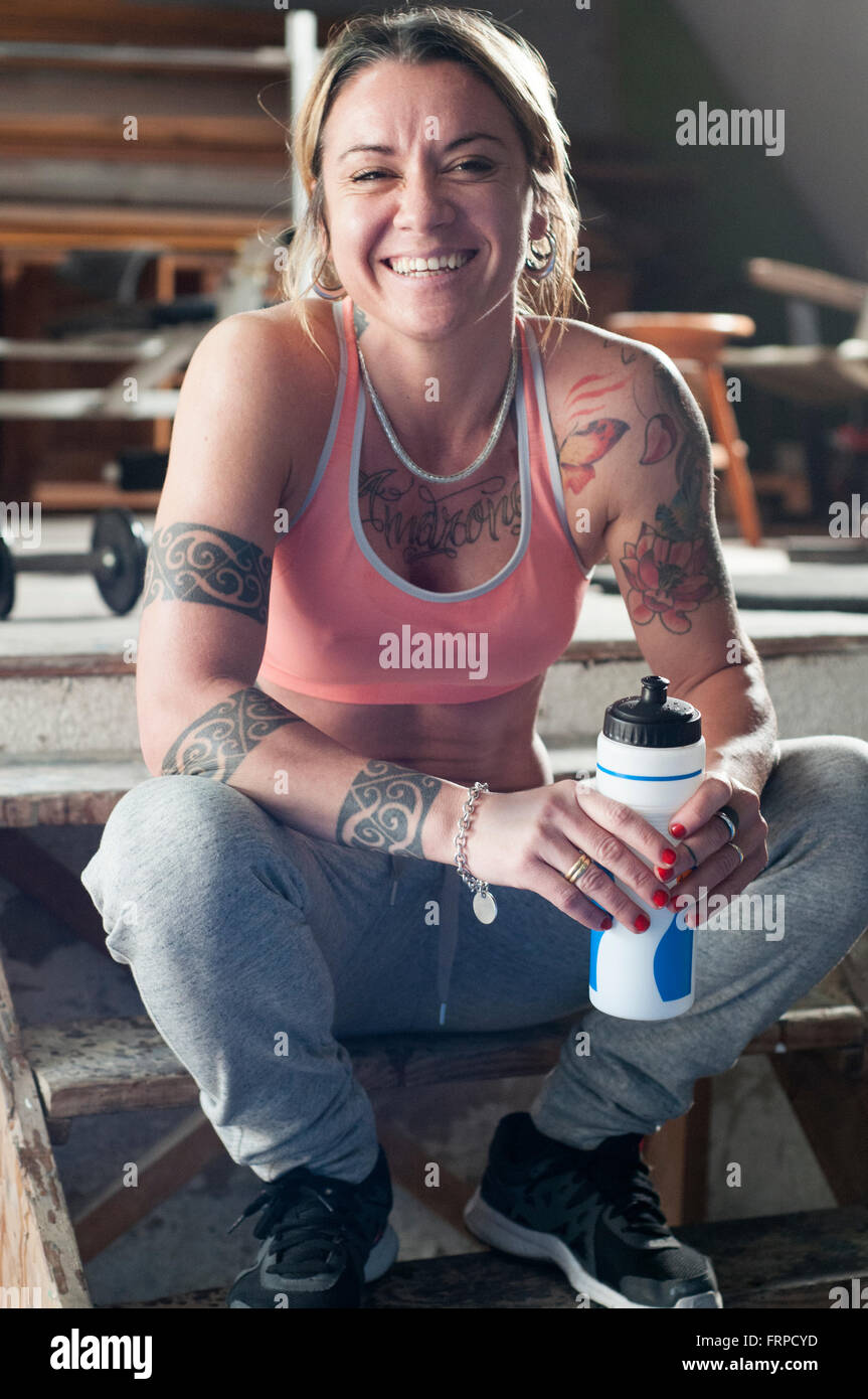 Woman looking at the camera and laughing after a hard workout Stock Photo