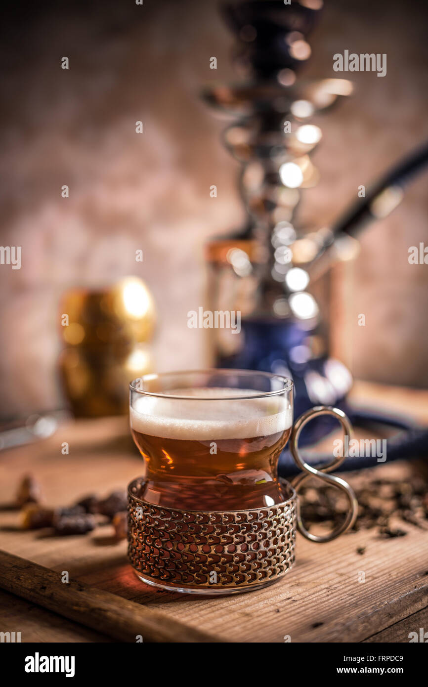 Glass cup of black tea on wooden table Stock Photo