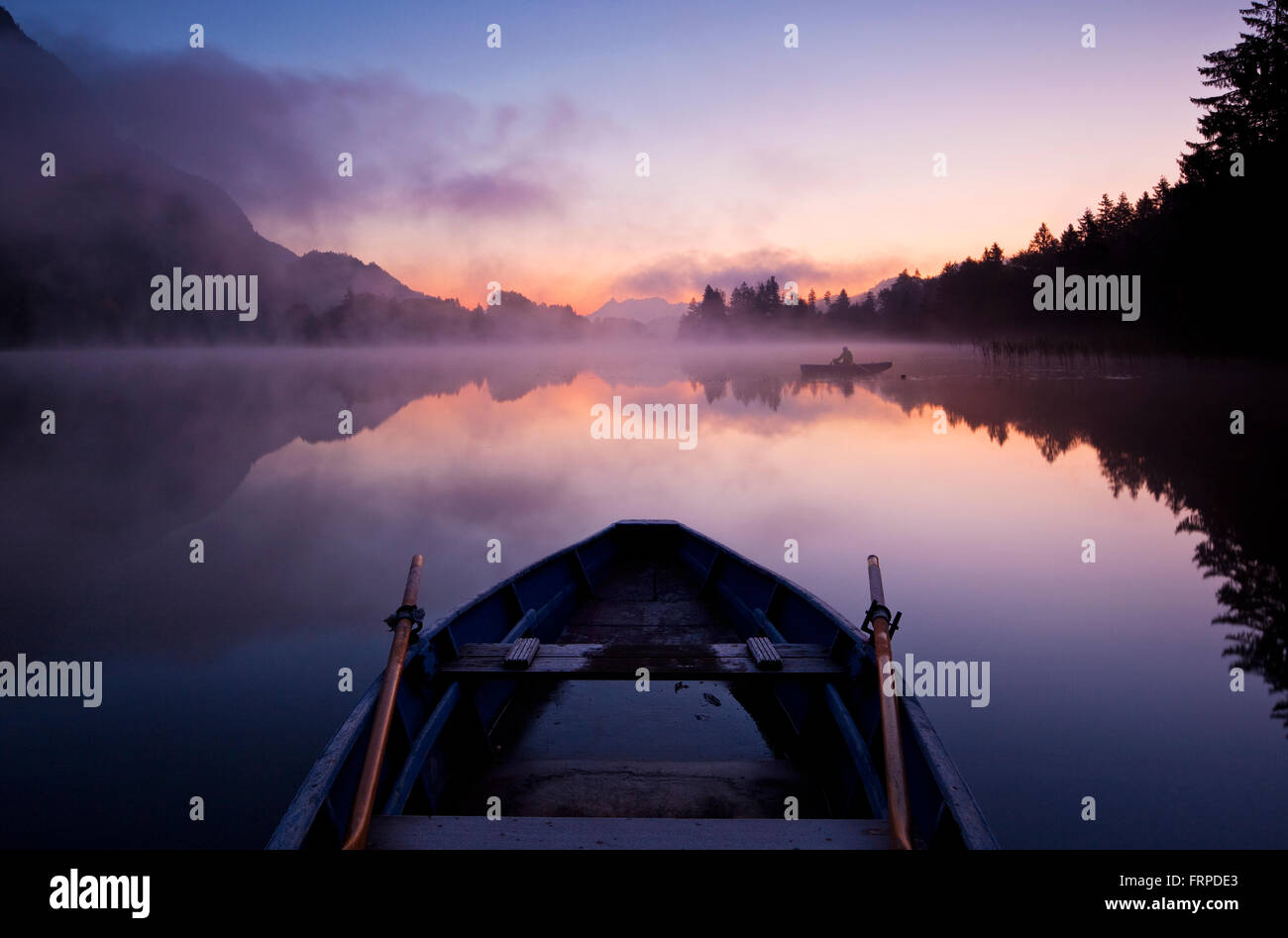 Rowing boat at dawn, Lake Reintal, Kramsach, Tyrol, Austria Stock Photo