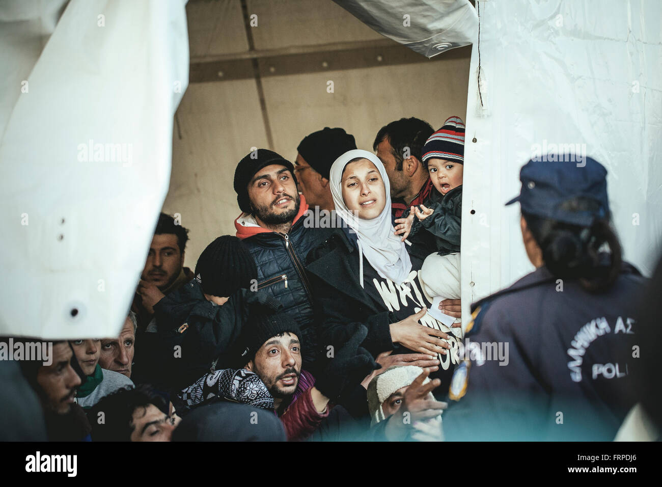 Idomeni refugee camp on the Greece-Macedonia border, Greek police brings refugees back into the waiting tent, waiting for the Stock Photo