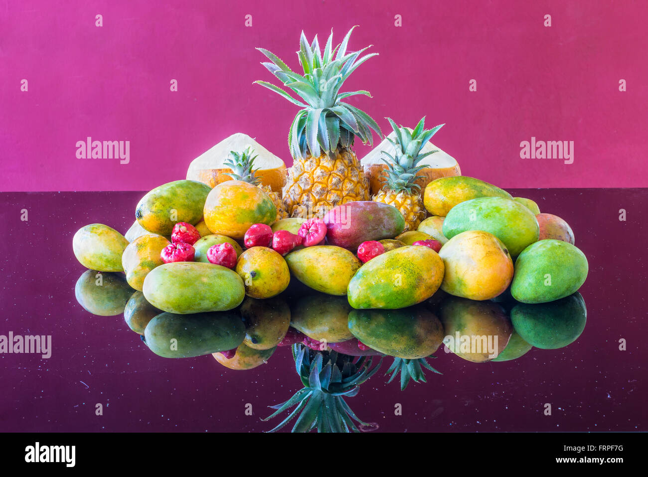 A selection of wellknown, famous market fresh tropical Mauritius fruit on a purple glass table