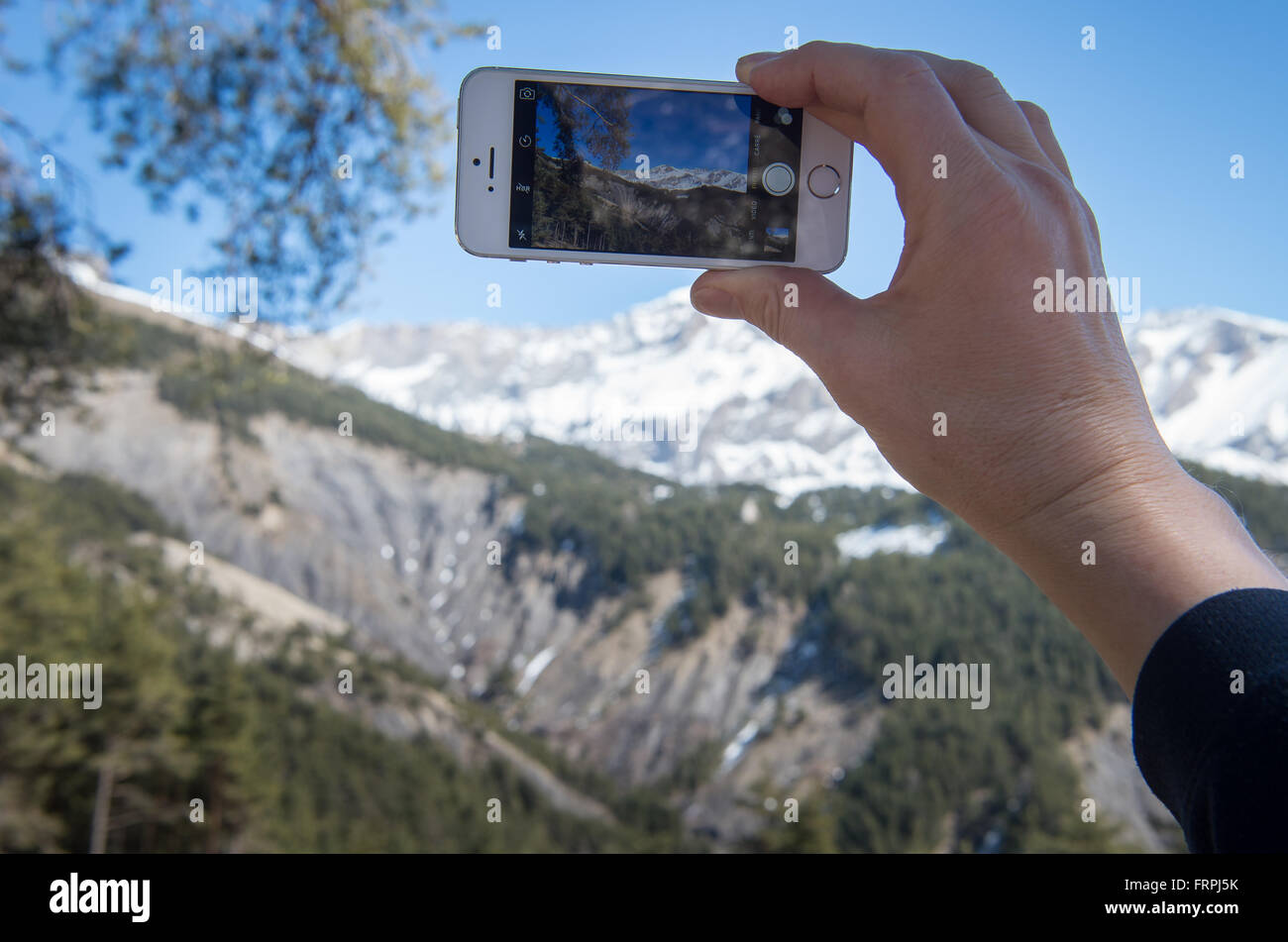 Le Vernet, France. 22nd Mar, 2016. A man takes pictures of the area near the Col de Mariaud where Germanwings flight 4U9525 crashed on 24 March 2015, near Le Vernet, France, 22 March 2016. One year after the crash of Germanwings flight 4U9525, family members are commemorating the 150 victims of the crash in Le Vernet. Photo: PETER KNEFFEL/dpa/Alamy Live News Stock Photo