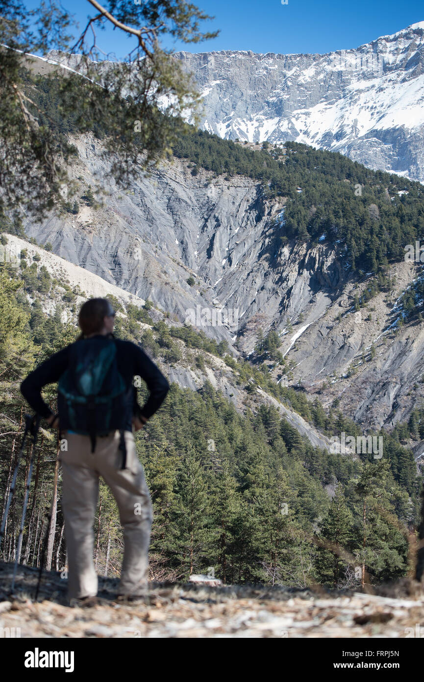 Le Vernet, France. 22nd Mar, 2016. A man looks at the area near the Col de Mariaud where Germanwings flight 4U9525 crashed on 24 March 2015, near Le Vernet, France, 22 March 2016. One year after the crash of Germanwings flight 4U9525, family members are commemorating the 150 victims of the crash in Le Vernet. Photo: PETER KNEFFEL/dpa/Alamy Live News Stock Photo