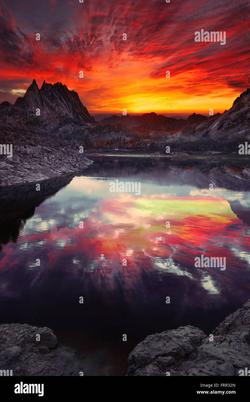 sunset orange clouds over the lake and mountains Stock Photo - Alamy