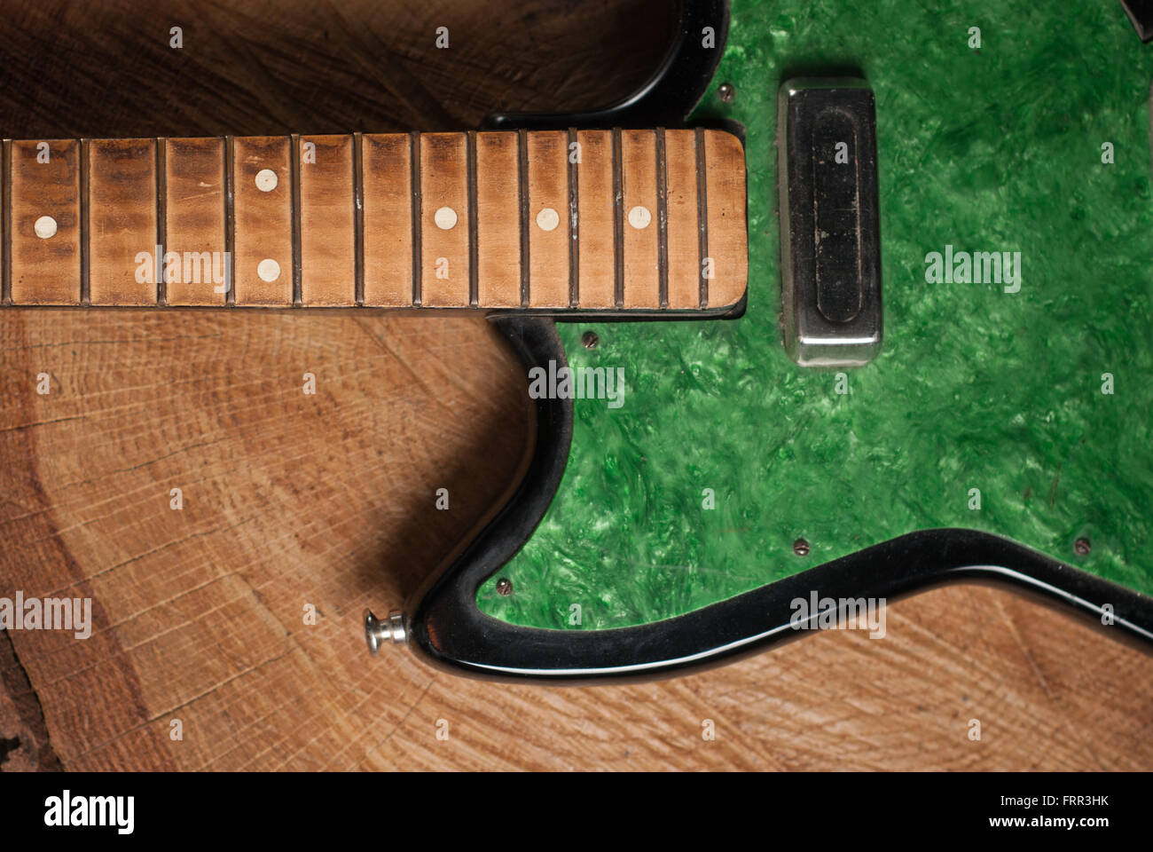 electric guitar without strings on wooden background, copy space Stock