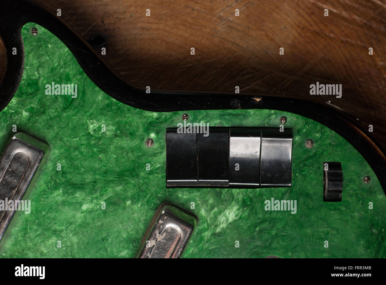 electric guitar without strings on wooden background, copy space Stock