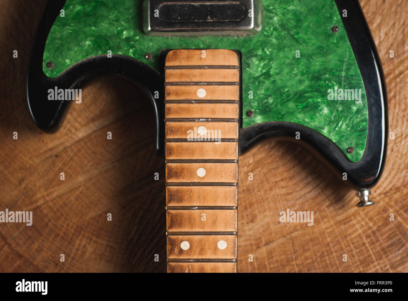 electric guitar without strings on wooden background, copy space Stock